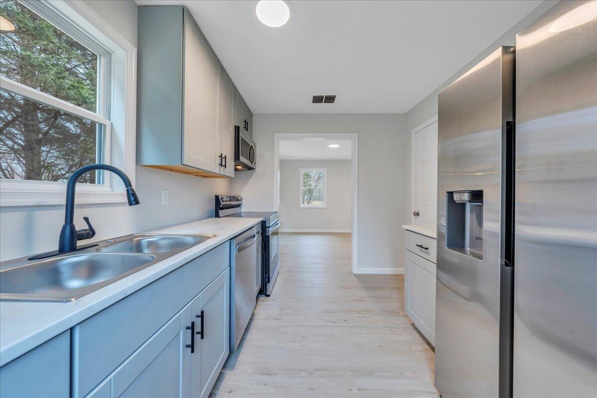 300 Ditto Branch Road Penhook, VA 24137 - Photo 8 of 29 a kitchen with stainless steel appliances granite countertop a sink and refrigerator