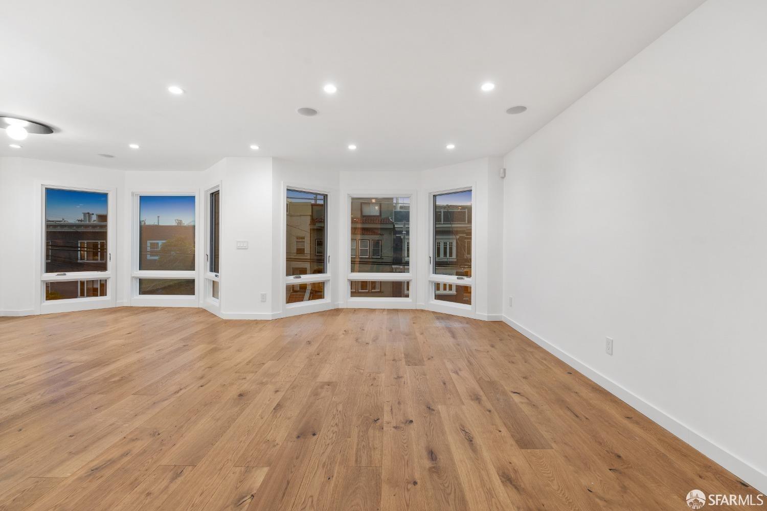174-172 18th Avenue, Unit 172 San Francisco, CA 94121 - Photo 14 of 37 a view of an empty room with wooden floor and a window