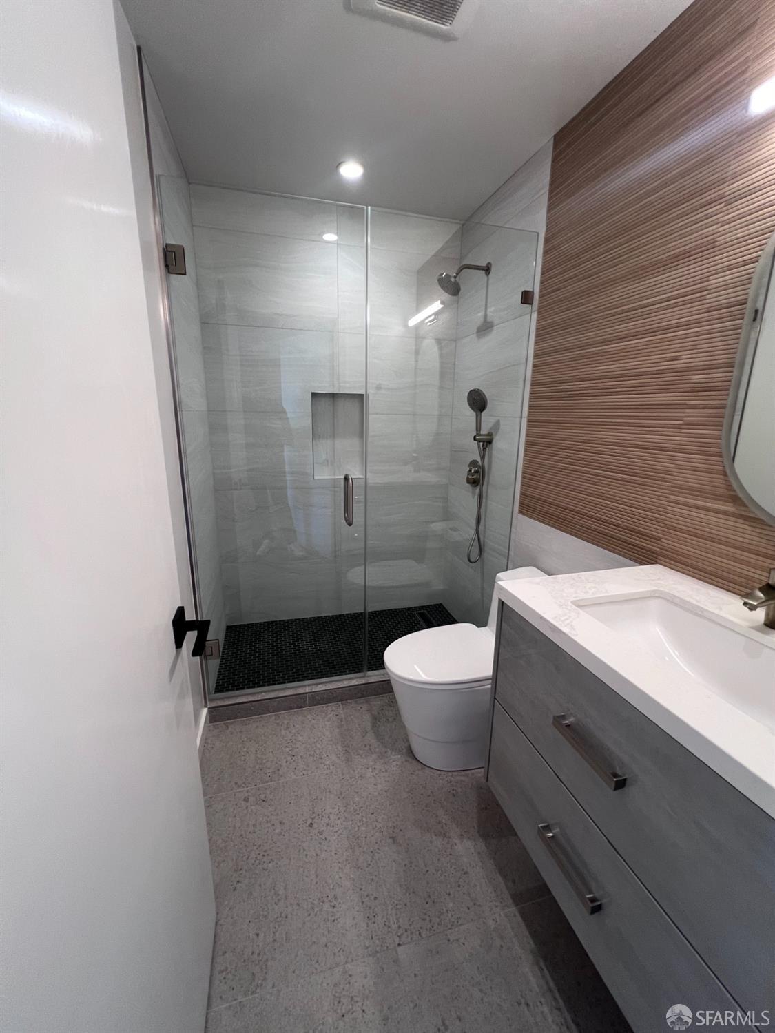 174-172 18th Avenue, Unit 172 San Francisco, CA 94121 - Photo 20 of 37 a bathroom with a sink a toilet and shower