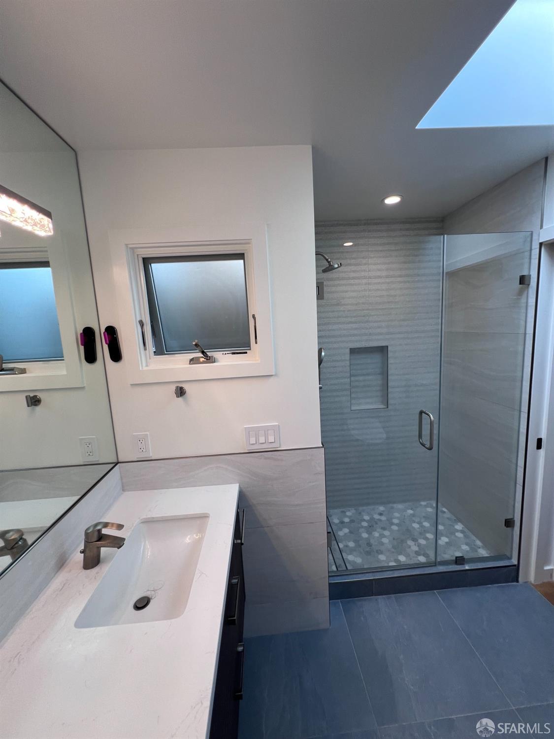 174-172 18th Avenue, Unit 172 San Francisco, CA 94121 - Photo 21 of 37 a bathroom with a sink a toilet and shower