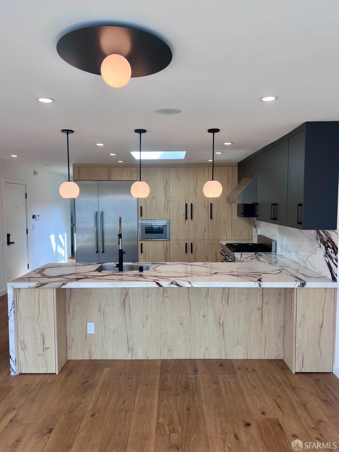 174-172 18th Avenue, Unit 172 San Francisco, CA 94121 - Photo 3 of 37 a large kitchen with a wooden floor