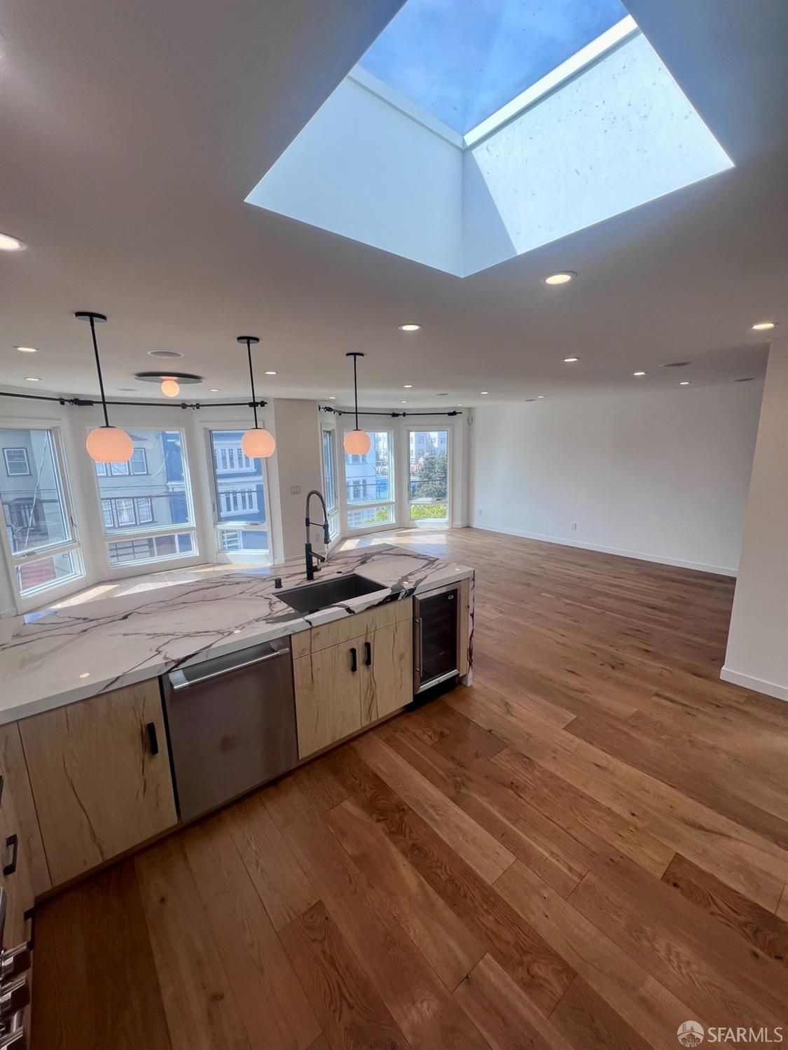 174-172 18th Avenue, Unit 172 San Francisco, CA 94121 - Photo 6 of 37 a large kitchen with stainless steel appliances a large counter top a stove and a refrigerator