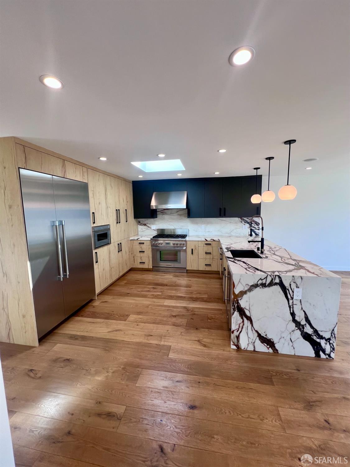 174-172 18th Avenue, Unit 172 San Francisco, CA 94121 - Photo 8 of 37 a kitchen with stainless steel appliances granite countertop a refrigerator sink and stove
