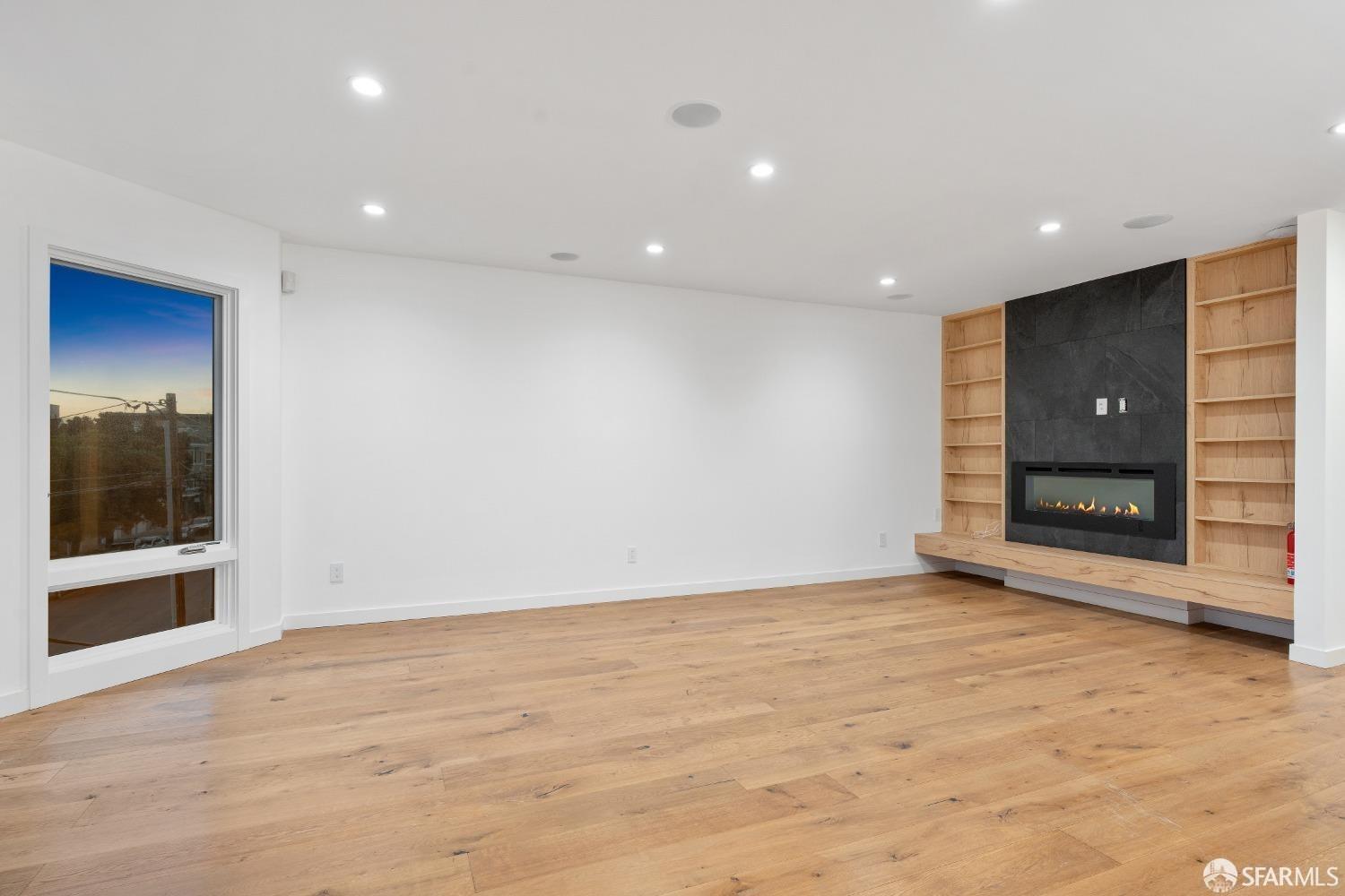 174-172 18th Avenue, Unit 172 San Francisco, CA 94121 - Photo 10 of 37 an empty room with wooden floor and door