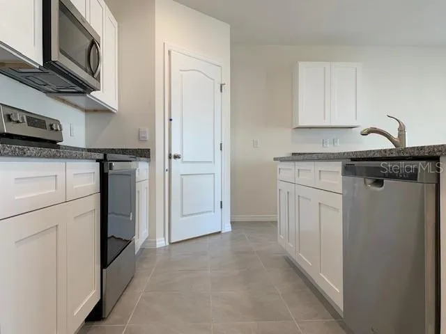 a kitchen with stainless steel appliances a refrigerator and a stove