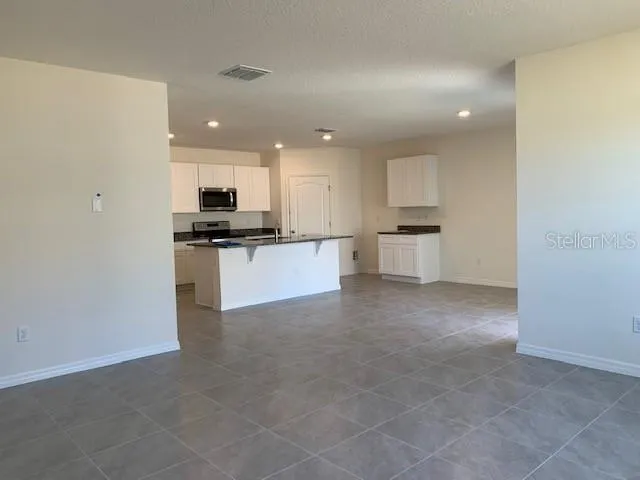 a view of a kitchen with a sink and a refrigerator