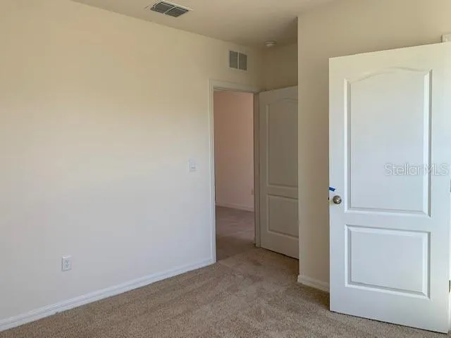 a bathroom with a granite countertop toilet and a sink
