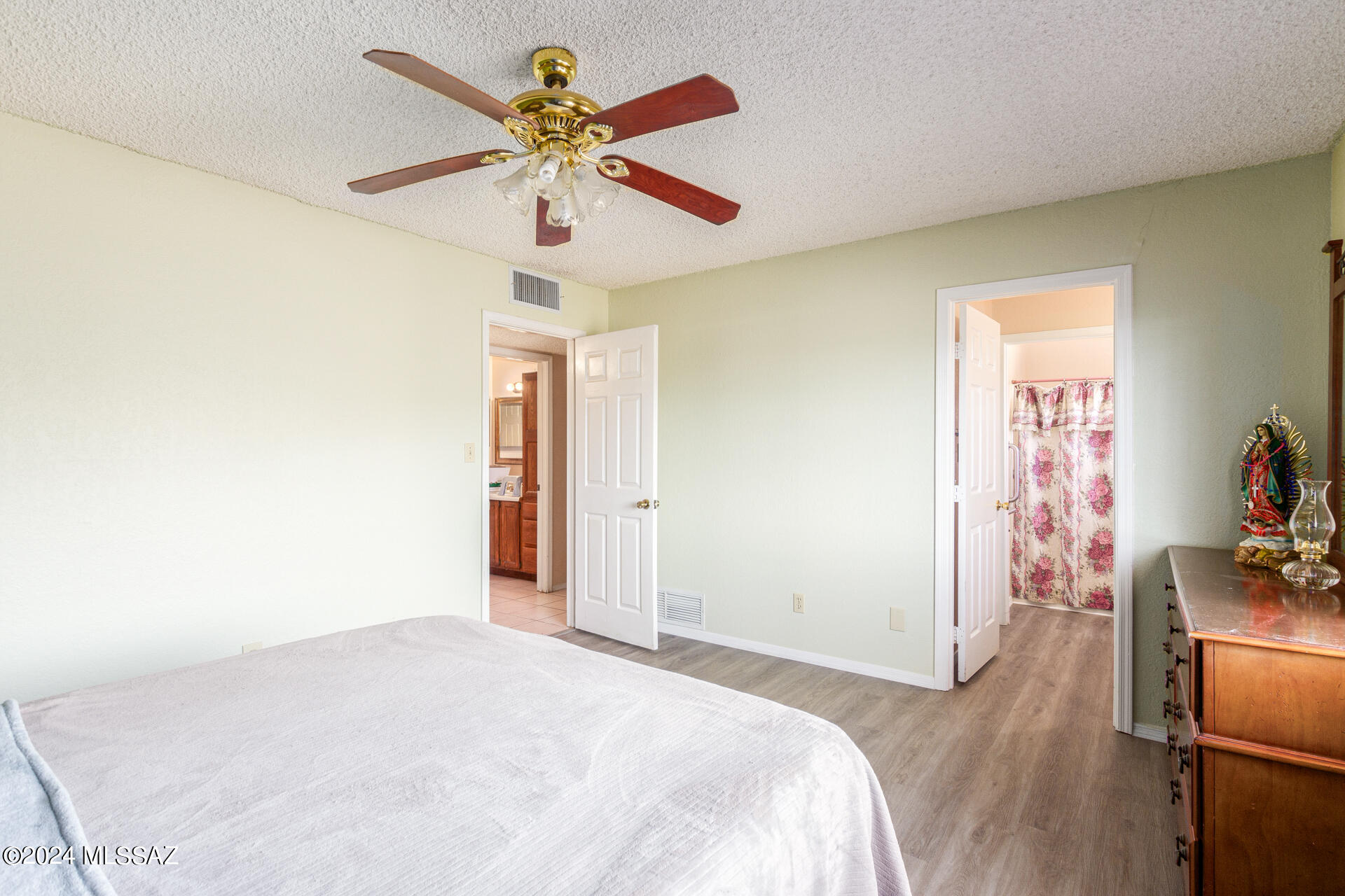 1232 Circulo Aguilar Rio Rico, AZ 85648 - Photo 21 of 32 a bedroom with a bed and a chandelier