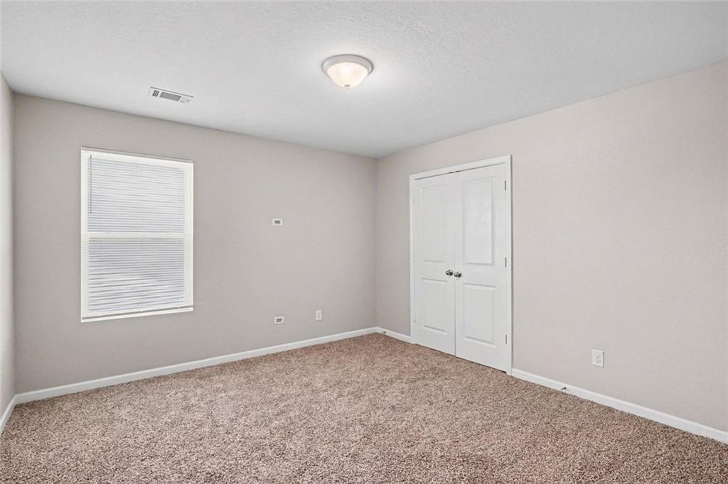 10941 Wheeler Trace Hampton, GA 30228 - Photo 11 of 21 a view of an empty room with a window