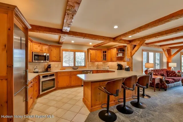 a kitchen with stainless steel appliances granite countertop sink stove and refrigerator