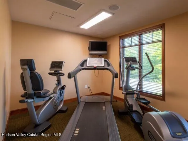 a view of a cafe with a table and chairs under an umbrella