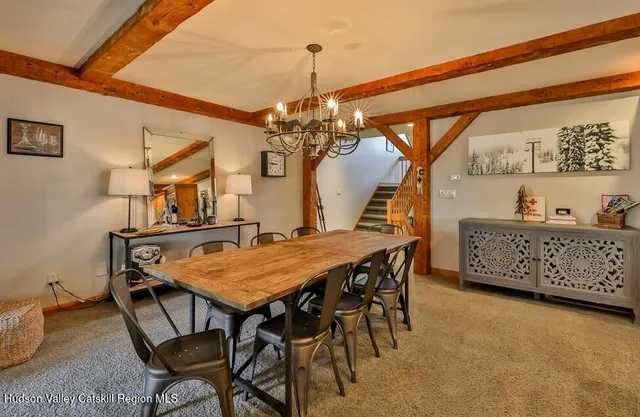 a dining room with a wooden table and chairs
