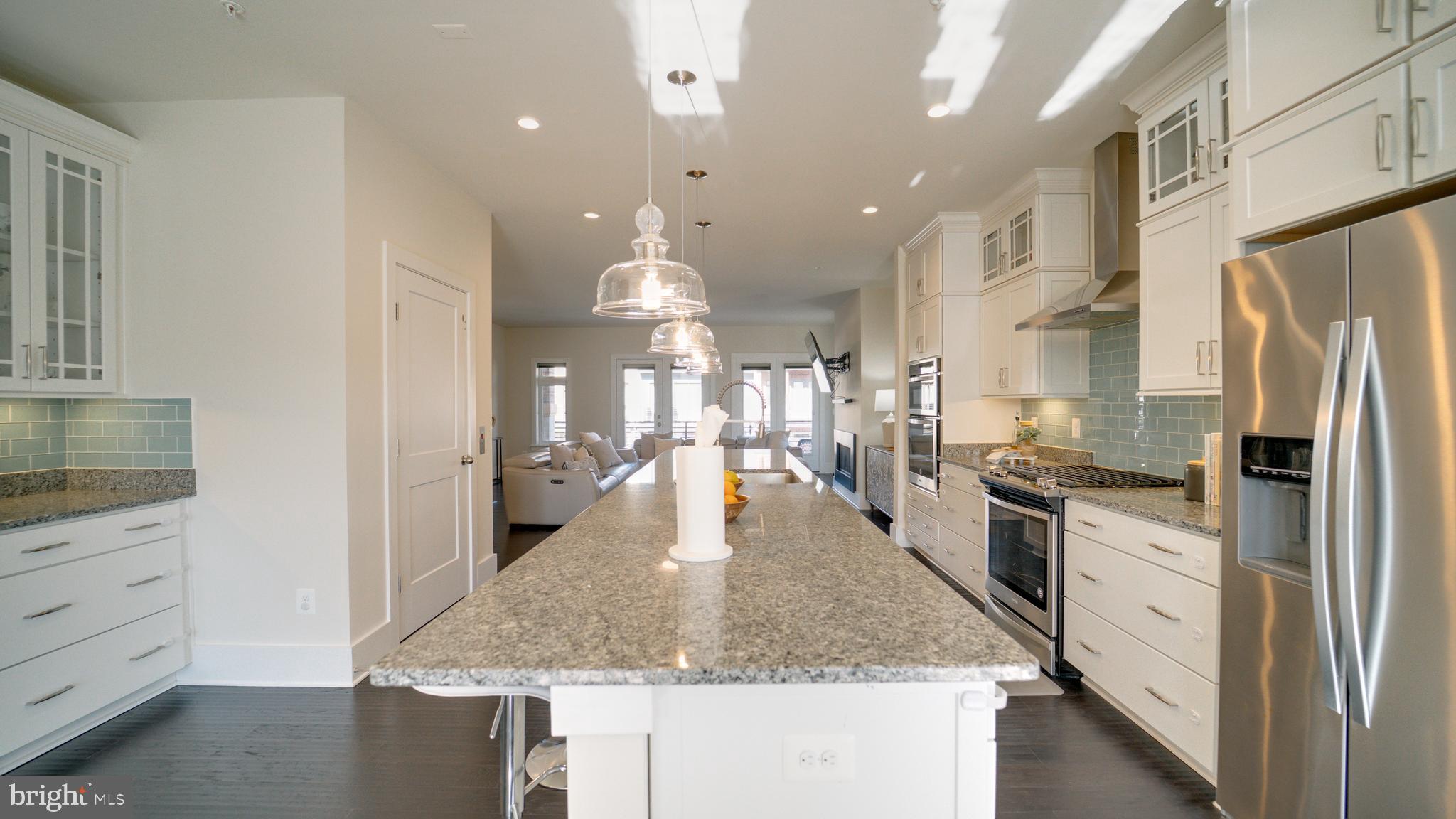 20062 Old Line Terrace Ashburn, VA 20147 - Photo 13 of 79 a kitchen with stainless steel appliances granite countertop a sink dishwasher a refrigerator and white cabinets with wooden floor