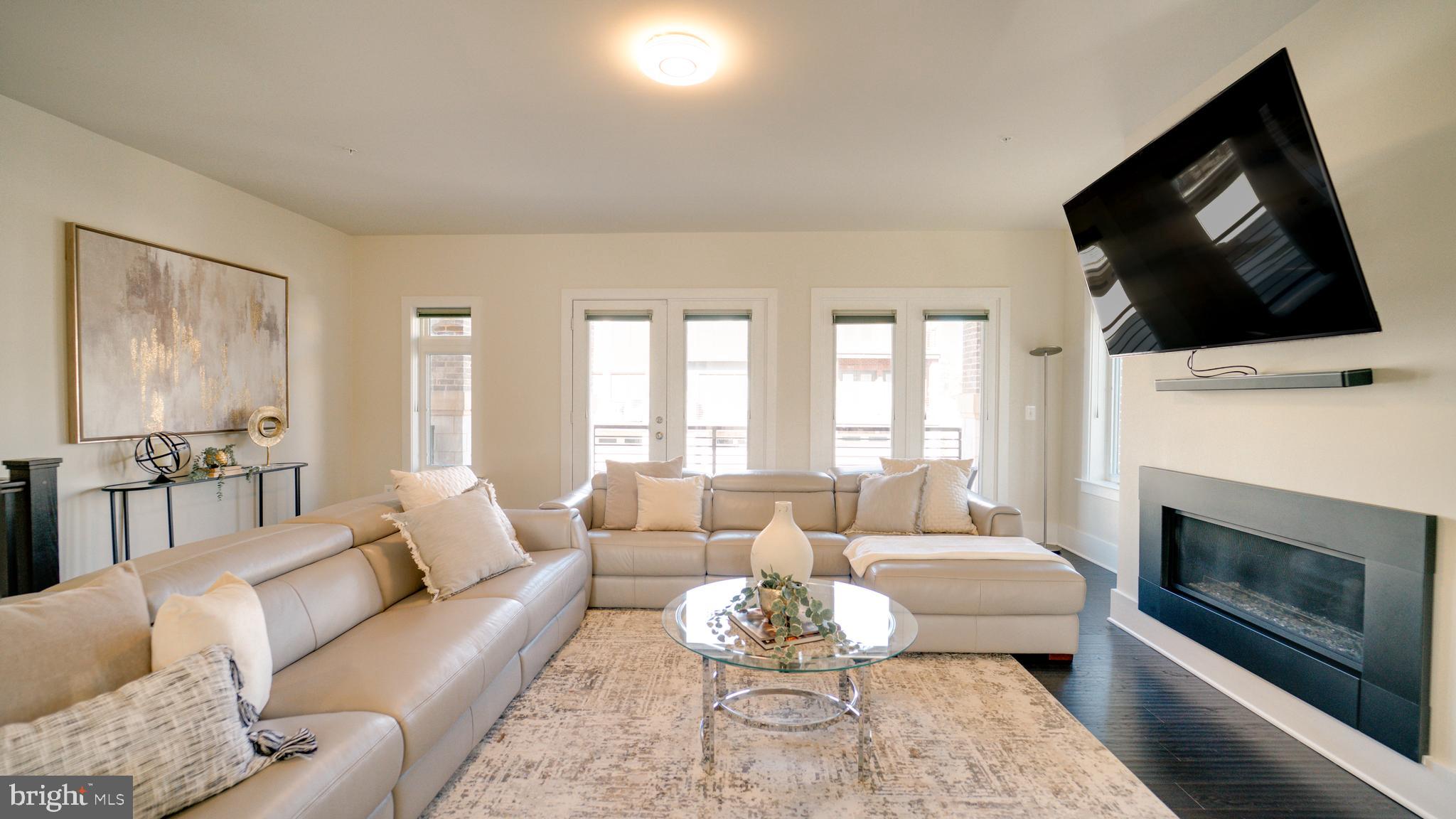 20062 Old Line Terrace Ashburn, VA 20147 - Photo 24 of 79 a living room with furniture a flat screen tv and a fireplace