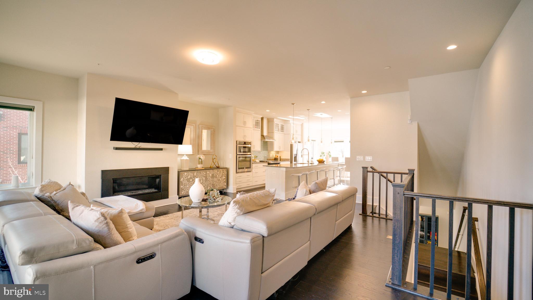 20062 Old Line Terrace Ashburn, VA 20147 - Photo 26 of 79 a living room with furniture a fireplace and a flat screen tv