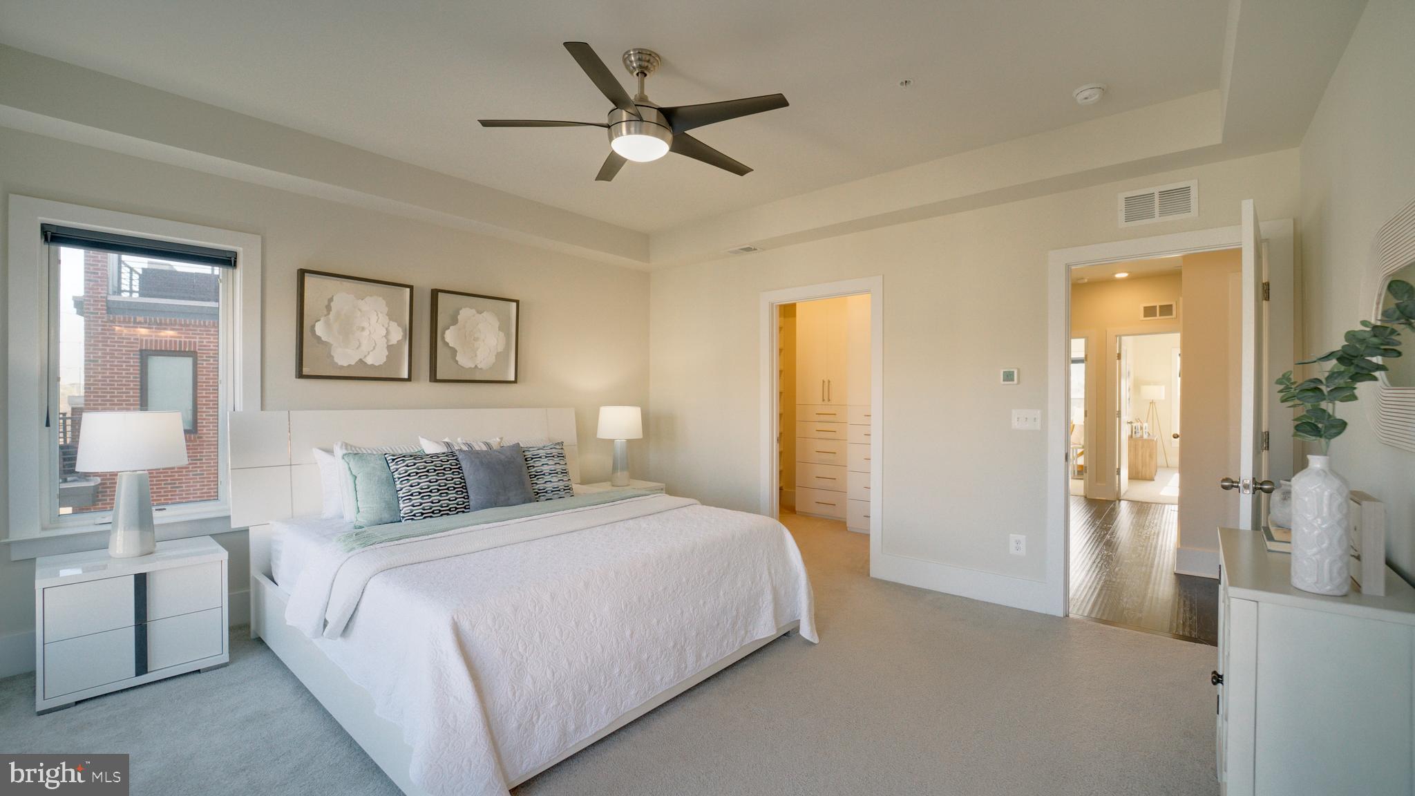 20062 Old Line Terrace Ashburn, VA 20147 - Photo 37 of 79 a bedroom with a large bed a chandelier and closet