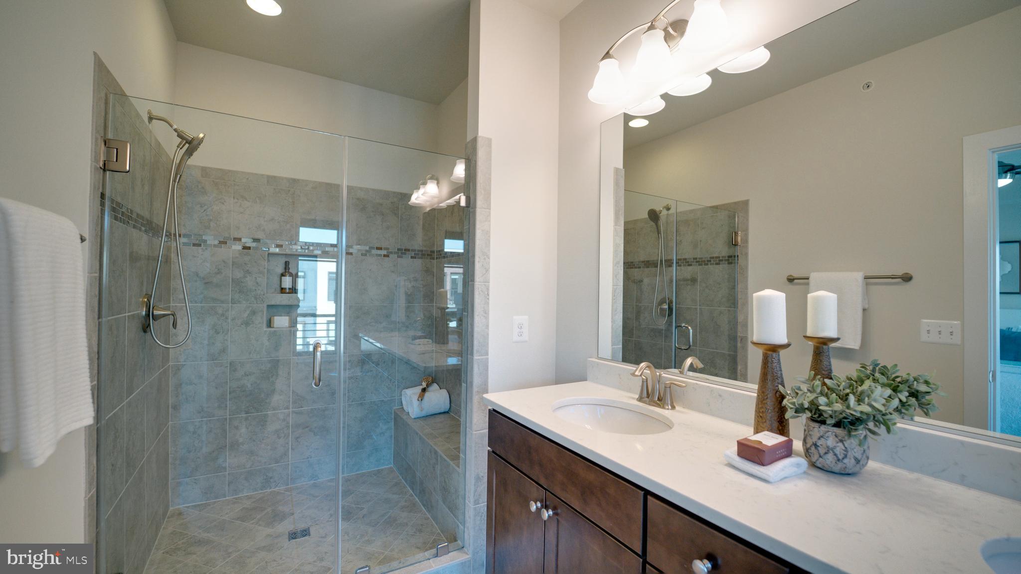 20062 Old Line Terrace Ashburn, VA 20147 - Photo 38 of 79 a bathroom with a shower sink vanity and mirror