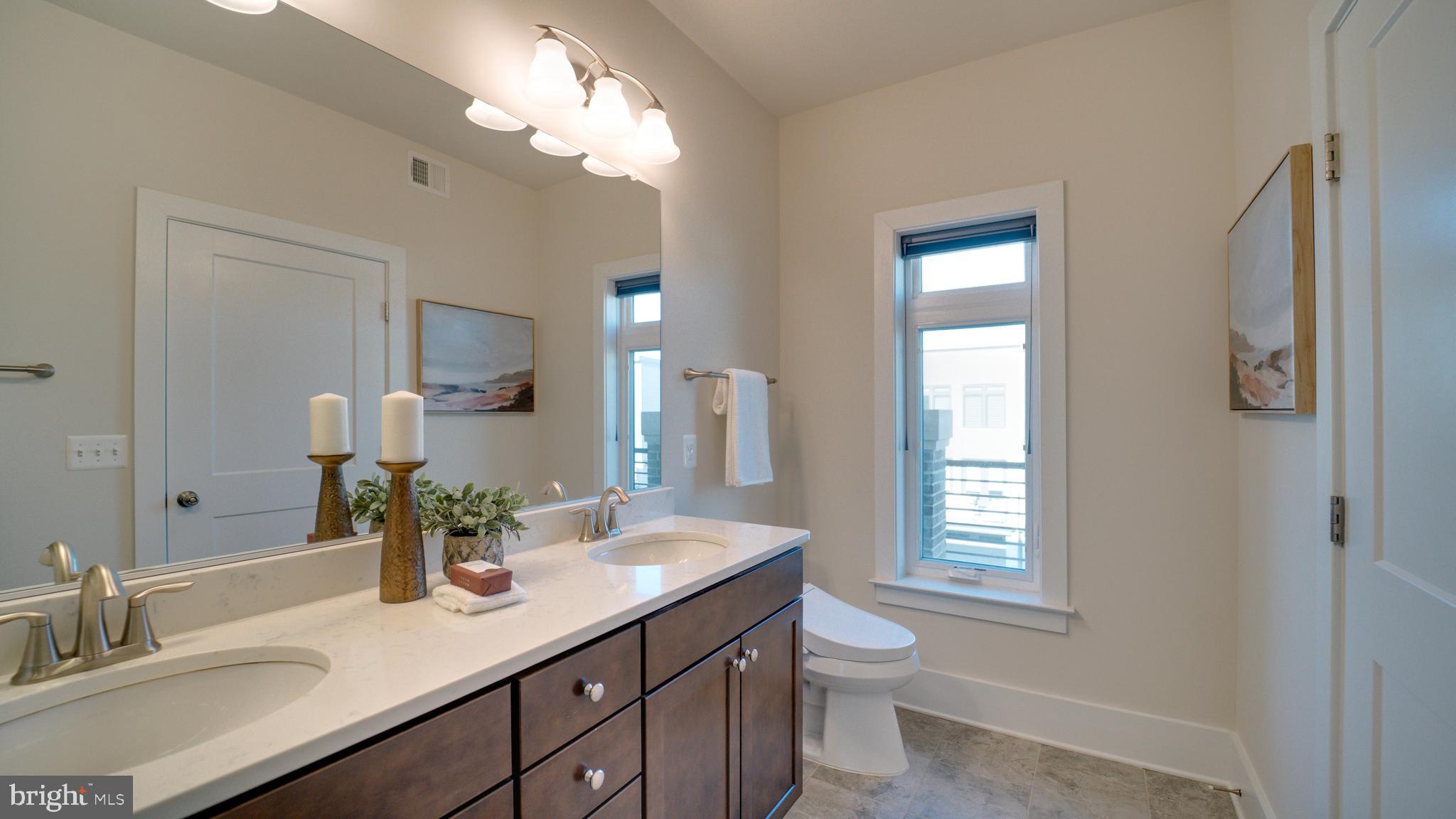 20062 Old Line Terrace Ashburn, VA 20147 - Photo 39 of 79 a bathroom with a granite countertop sink a toilet and a mirror