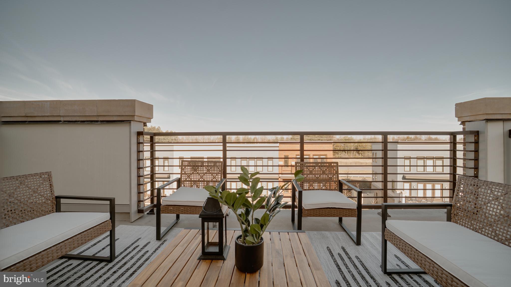 20062 Old Line Terrace Ashburn, VA 20147 - Photo 62 of 79 a view of a balcony with chairs and wooden floor