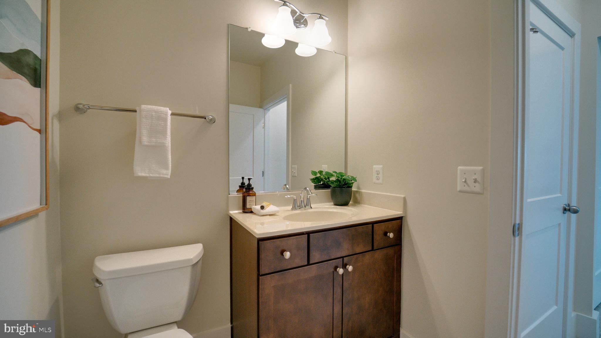 20062 Old Line Terrace Ashburn, VA 20147 - Photo 68 of 79 a bathroom with a toilet sink and mirror