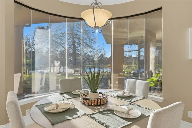 a spacious bathroom with a granite countertop sink a mirror a vanity and a shower