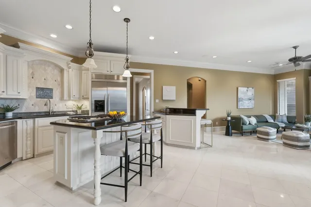 a spacious bathroom with a granite countertop sink a large mirror and a bathtub