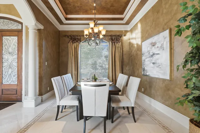 a living room with furniture potted plant and a large window