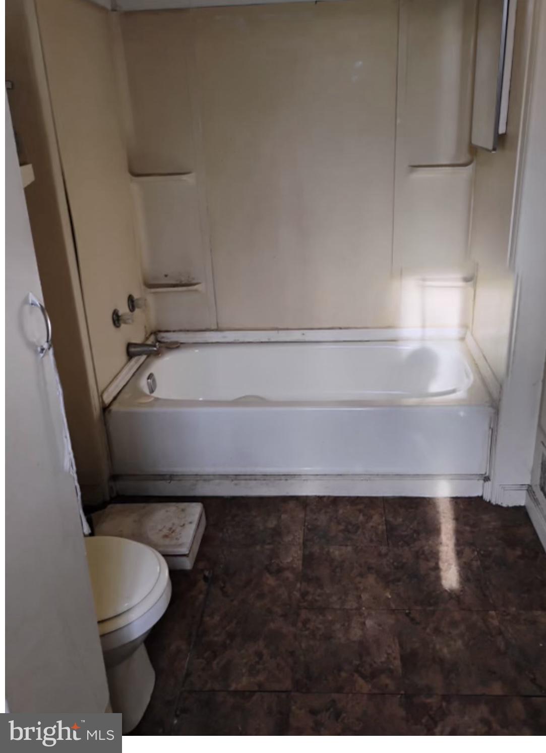 1928 Frederick Avenue Baltimore, MD 21223 - Photo 5 of 6 a bathroom with a toilet a sink and a mirror
