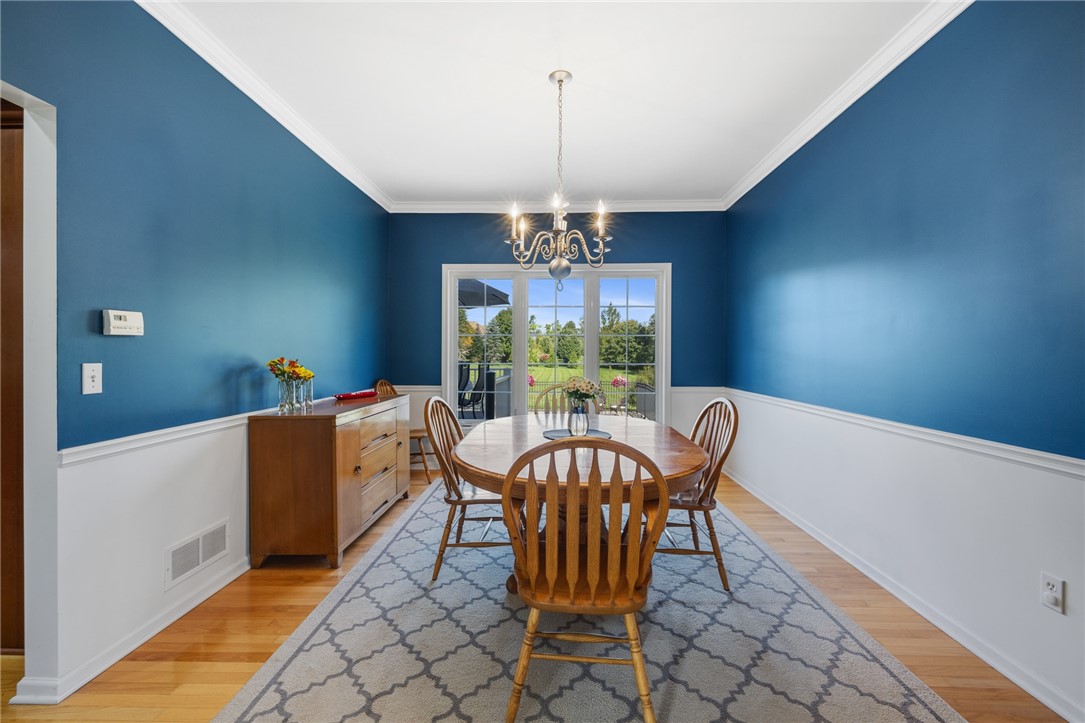 1782 Sweets Corners Road Penfield, NY 14450 - Photo 10 of 49 Classic crown molding and rich hardwood floors frame this formal dining room.