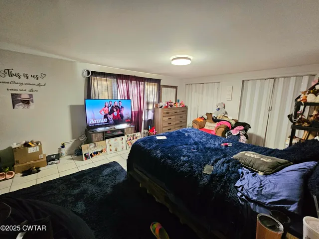 a bedroom with bed and a window