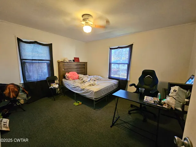 a bedroom with a bed gym equipment and a mirror