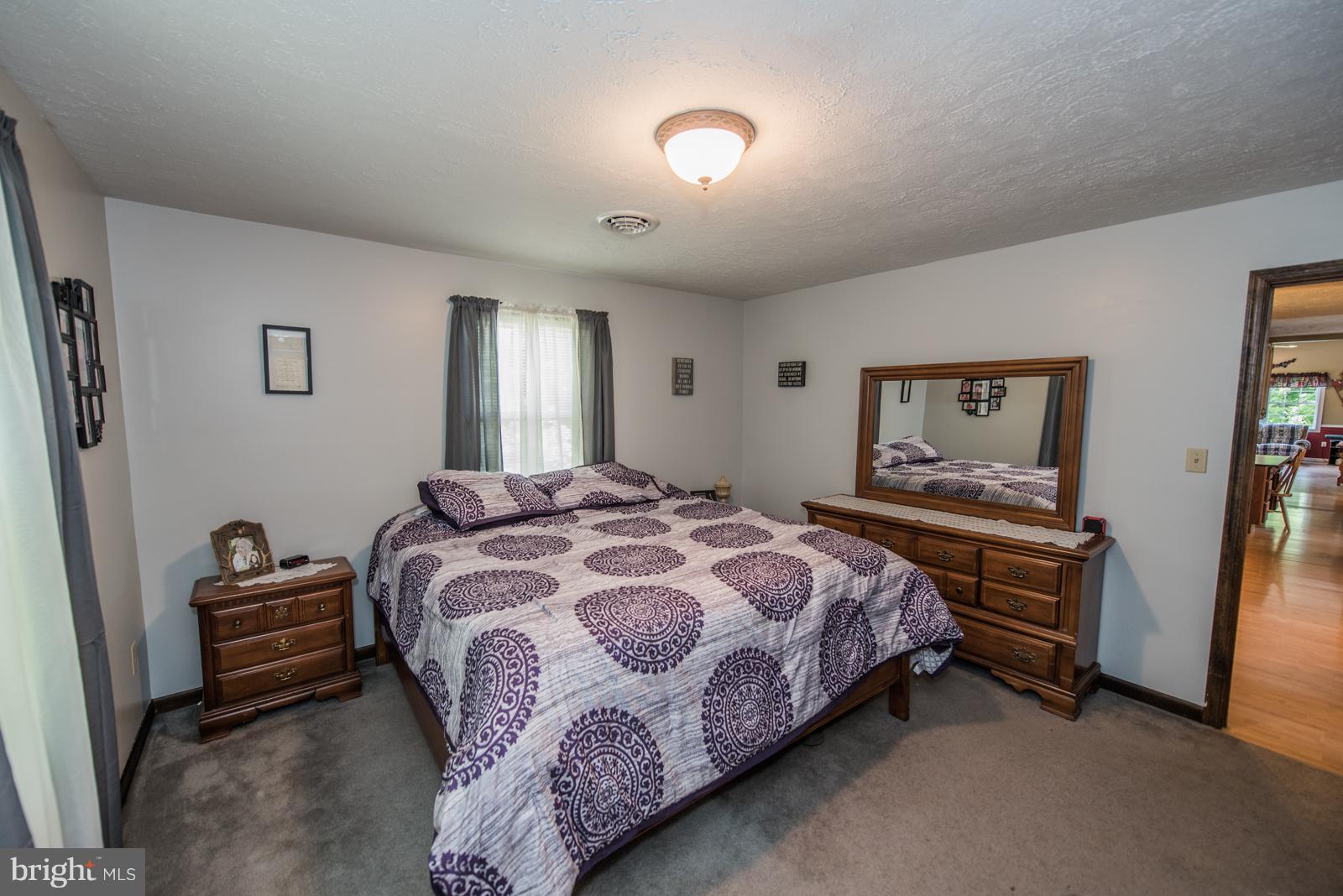 195 Messick Road Strasburg, VA 22657 - Photo 22 of 30 a bedroom with a bed and a chandelier