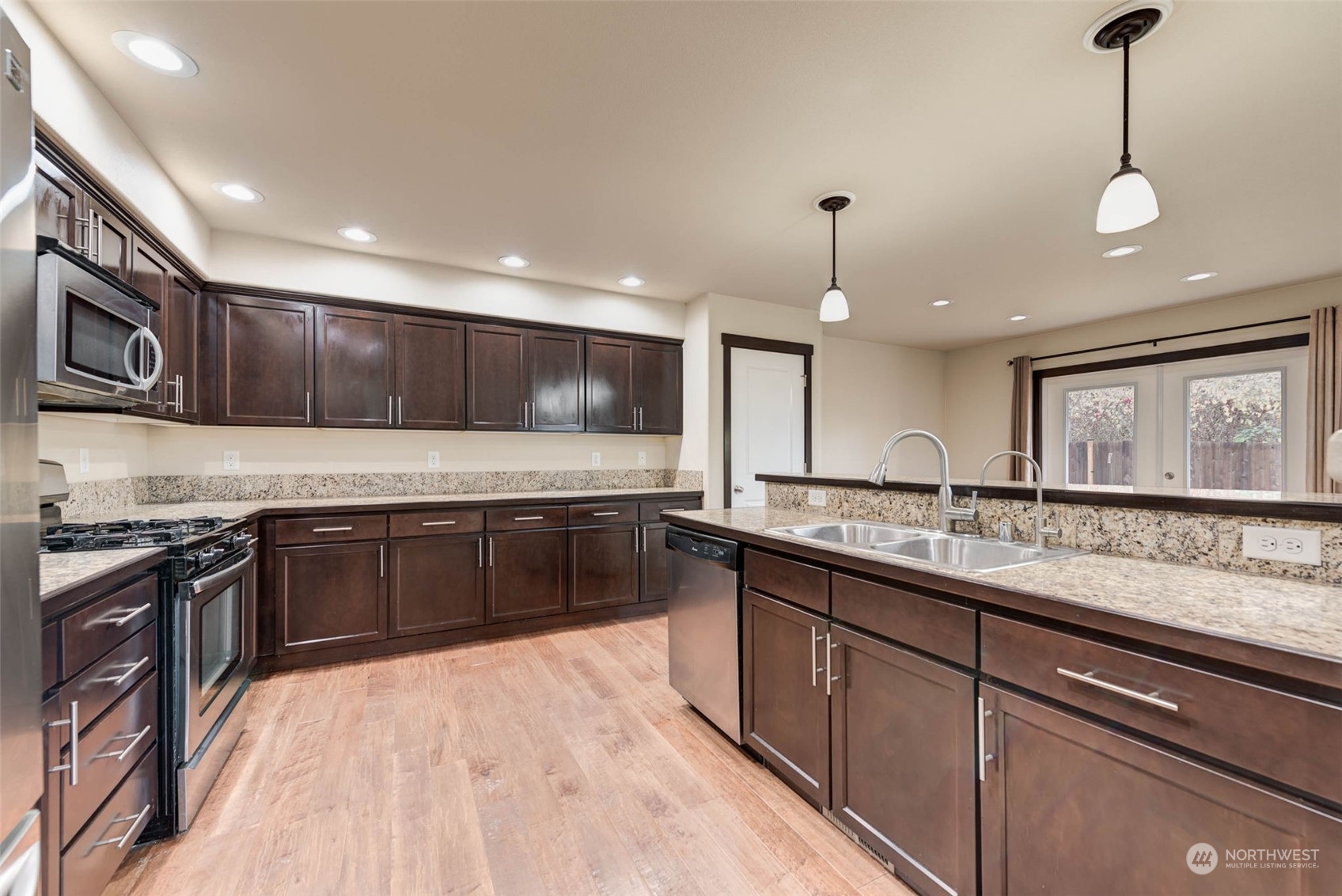 448 Barry Loop Mount Vernon, WA 98274 - Photo 19 of 40 a kitchen with stainless steel appliances granite countertop wooden cabinets a stove a sink and a oven