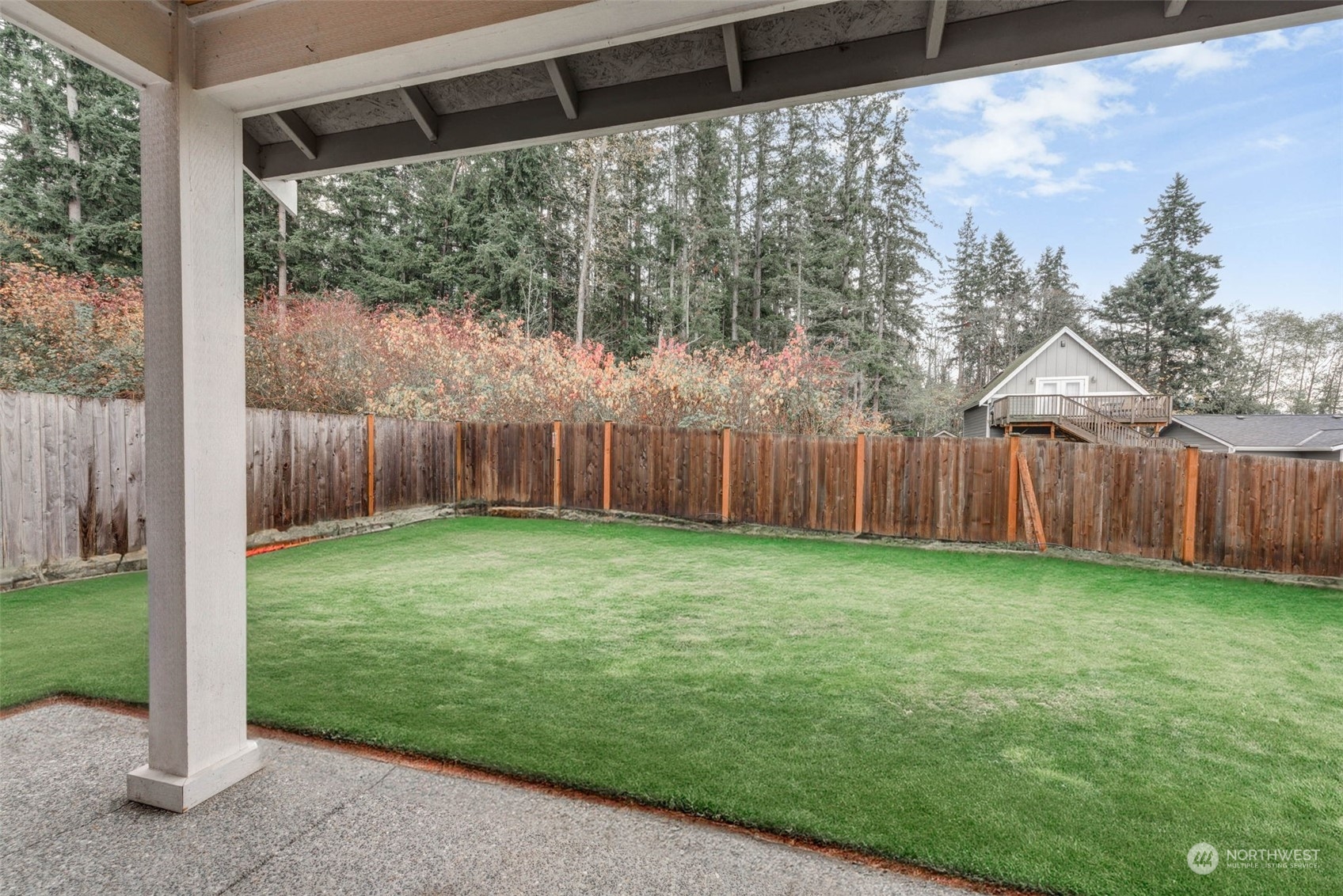 448 Barry Loop Mount Vernon, WA 98274 - Photo 36 of 40 a view of a backyard with large trees and wooden fence