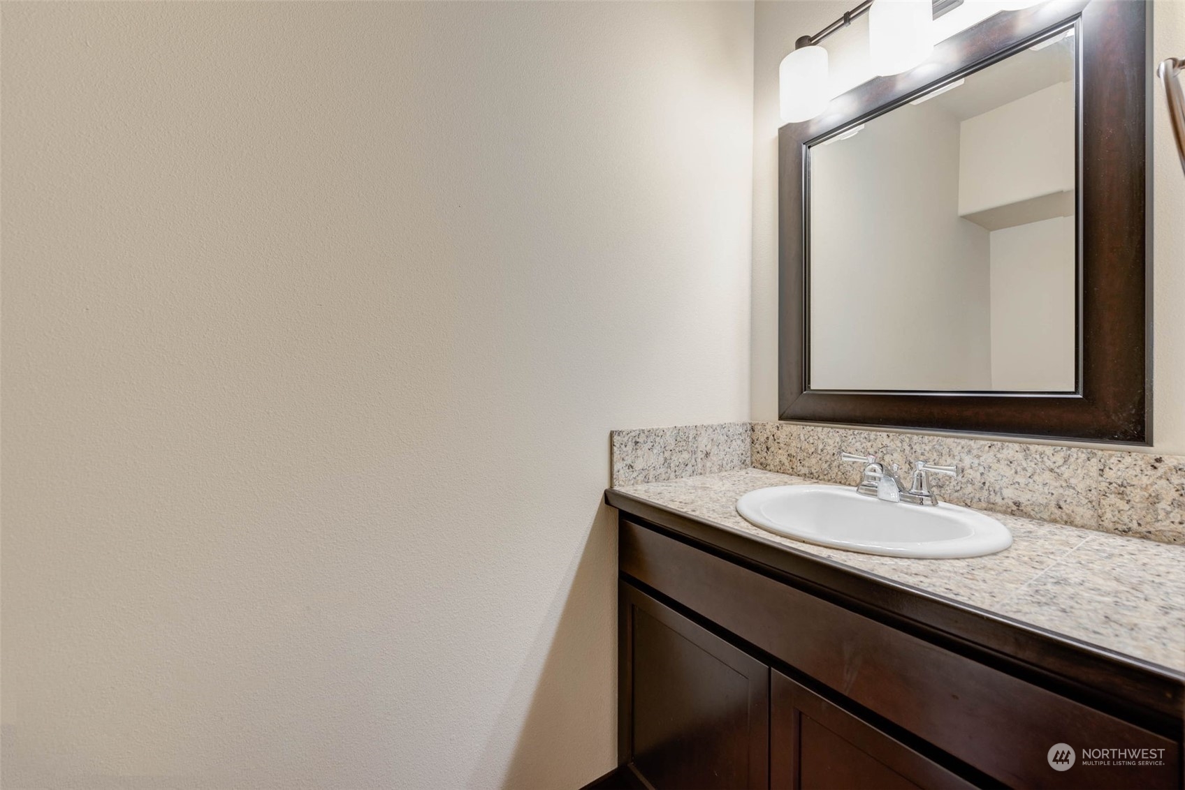 448 Barry Loop Mount Vernon, WA 98274 - Photo 6 of 40 a bathroom with a granite countertop sink and a mirror