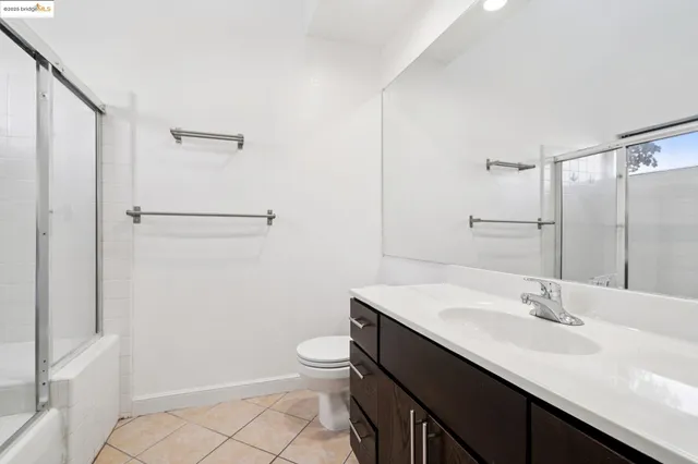 a bathroom with a sink a toilet a shower and a mirror