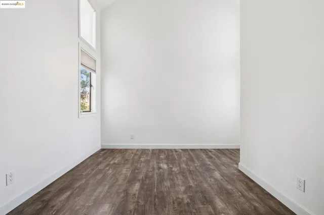 a view of room with wooden floor