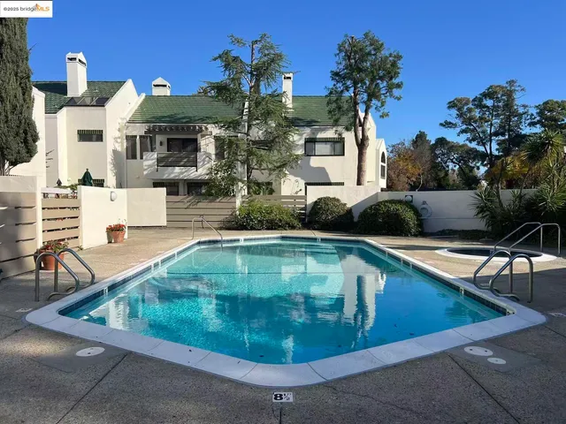 a view of a house with swimming pool and sitting area