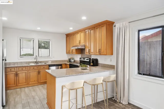 a kitchen with a sink a window and cabinets