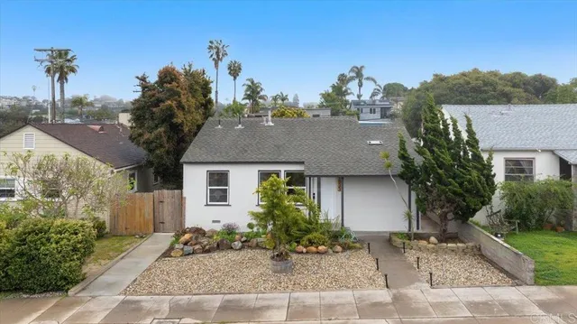front view of a house with potted plants
