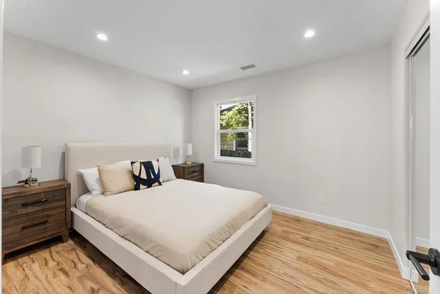 a bedroom with a bed and a window