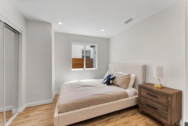 a bedroom with a bed and lamps