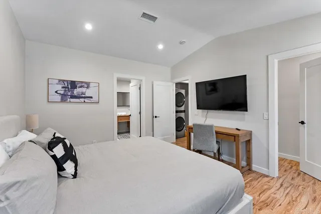 a bedroom with a bed and a flat screen tv