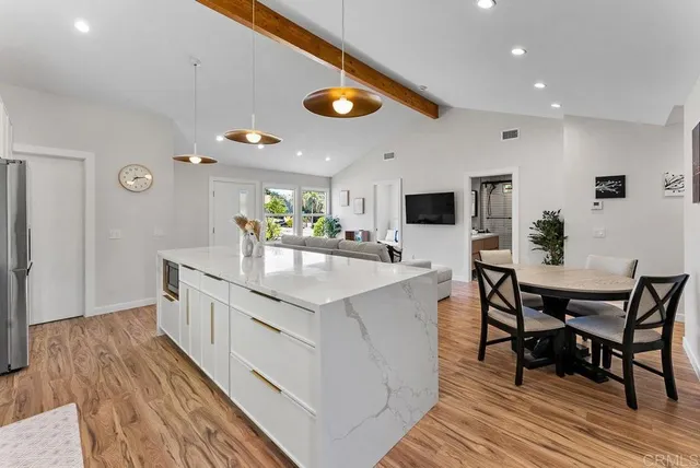 a kitchen with stainless steel appliances granite countertop counter space and wooden floor