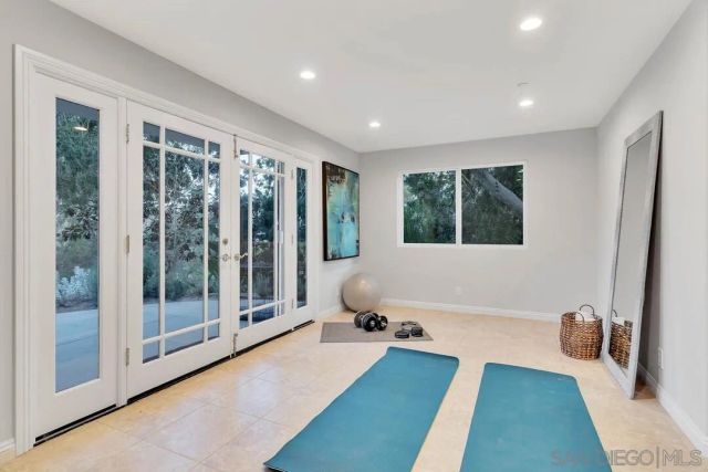 a spacious bedroom with a large bed and a chandelier