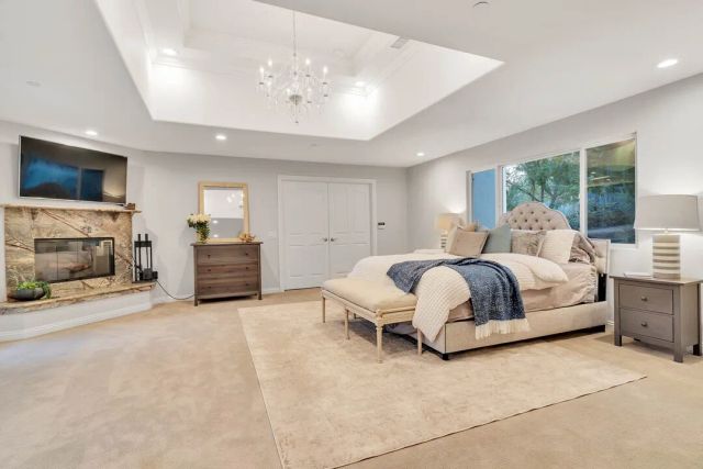 a spacious bedroom with a bed and a couch