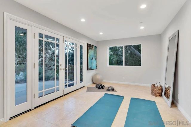 a spacious bedroom with a large bed and a chandelier