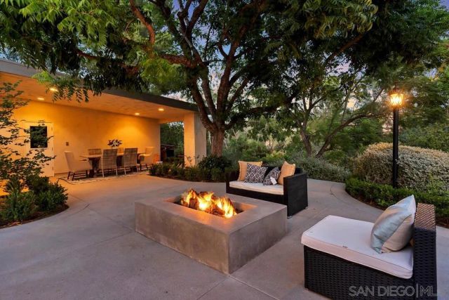 a view of a patio with couches and a fire pit
