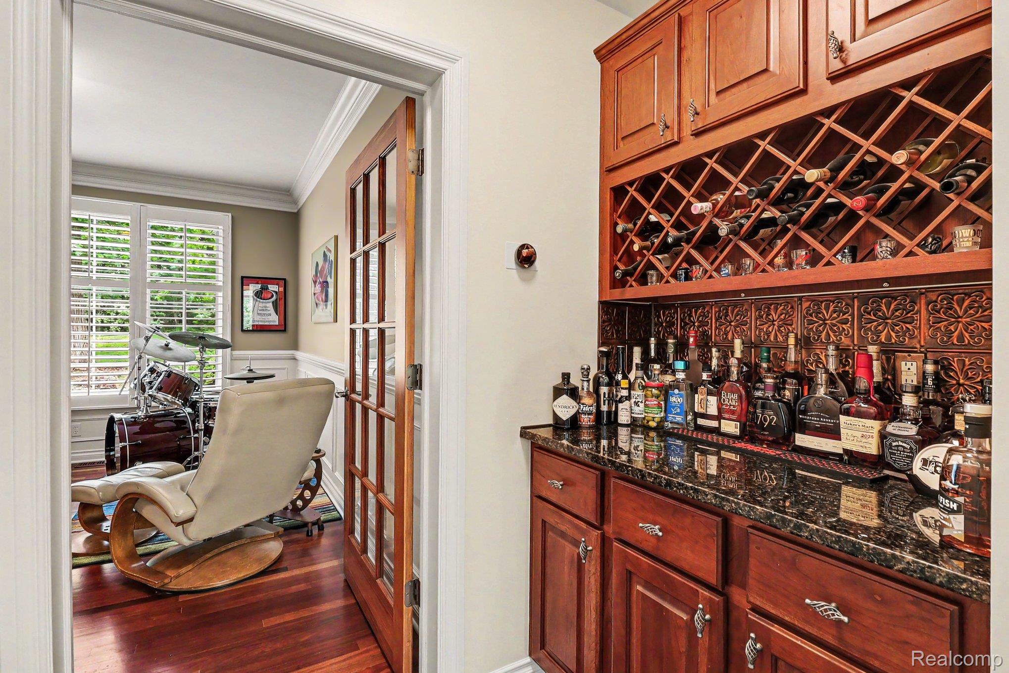 10490 Deer Ridge Trail Holly, MI 48442 - Photo 18 of 56 Built-in wet bar with wood cabinetry, granite-style countertop, and integrated wine storage