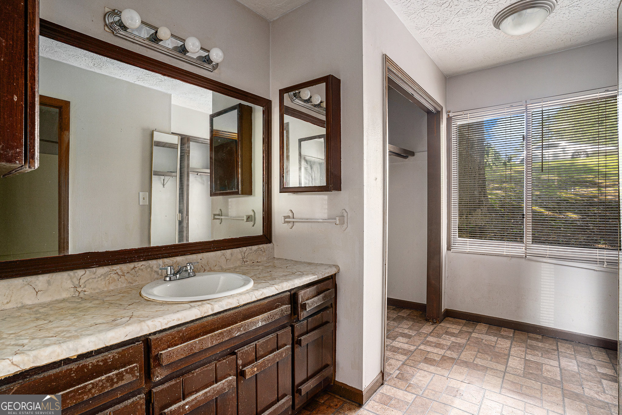 1341 Bethaven Road Riverdale, GA 30296 - Photo 11 of 18 a bathroom with a sink a vanity and a mirror